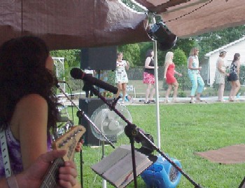 Click for enlarged view. Conga line at a poolside wedding reception in July.